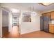 Kitchen area with wood cabinets and a pass-through to the living room at 7950 E Keats Ave # 130, Mesa, AZ 85209
