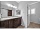 Bathroom with double vanity, granite countertop, and access to a small water closet at 28308 N 157Th Pl, Scottsdale, AZ 85262