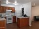 Kitchen with wood cabinets, island, and white appliances at 1502 W Shangri La Rd, Phoenix, AZ 85029