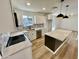 Modern kitchen with an island, white cabinets and dark-colored island at 2213 E Janice Way, Phoenix, AZ 85022