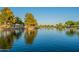 Picturesque lake view with reflection of trees and sky at 45680 W Barbara Ln, Maricopa, AZ 85139