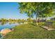 Scenic lake view with a bench and bridge in the background at 45680 W Barbara Ln, Maricopa, AZ 85139