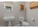 Bathroom with pedestal sink, toilet and wall-mounted cabinet at 2237 N Calle Largo --, Mesa, AZ 85207