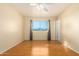 Well-lit bedroom featuring wood floors and a ceiling fan at 10908 W Peoria Ave, Sun City, AZ 85351