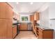 Galley style kitchen with wood cabinets and stainless steel appliances at 10908 W Peoria Ave, Sun City, AZ 85351