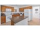 Kitchen with wood cabinets and an island at 45680 W Barbara Ln, Maricopa, AZ 85139