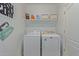 Laundry room with washer, dryer, and shelving at 45680 W Barbara Ln, Maricopa, AZ 85139