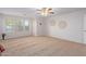 Spacious carpeted bedroom with large windows and ceiling fan at 45680 W Barbara Ln, Maricopa, AZ 85139