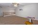 Spacious loft area with carpet and a ceiling fan at 45680 W Barbara Ln, Maricopa, AZ 85139