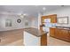 Kitchen with island, wood cabinets, and white appliances at 45680 W Barbara Ln, Maricopa, AZ 85139