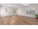 Bright living room featuring wood-look flooring and a large window at 45680 W Barbara Ln, Maricopa, AZ 85139