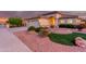 Landscaped front yard with artificial turf and stone accents at 16513 W Windsor Ave, Goodyear, AZ 85395