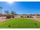 Scenic view of a lush green golf course with homes in the background at 16513 W Windsor Ave, Goodyear, AZ 85395