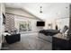 Main bedroom with sliding doors to a patio and a large TV at 160 N Shore Ln, Gilbert, AZ 85233