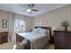 Main bedroom with king-size bed, nightstands, and ceiling fan at 145 N 74Th St # 241, Mesa, AZ 85207