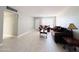 Spacious living area with wood-look tile floors and a view into the dining area at 4936 E Coronado Rd, Phoenix, AZ 85008