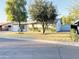 Ranch-style home with a spacious yard, mature trees, and a detached shed at 4936 E Coronado Rd, Phoenix, AZ 85008