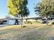 Ranch-style home with a large yard, featuring mature trees and a well-maintained lawn at 4936 E Coronado Rd, Phoenix, AZ 85008