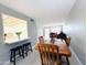 Dining area with wooden table and chairs, kitchen pass-through, and access to living room at 4936 E Coronado Rd, Phoenix, AZ 85008