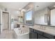 Spa-like bathroom with double sinks, a soaking tub, and a walk-in shower at 18577 W Coolidge St, Goodyear, AZ 85395