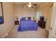 Cozy bedroom with ceiling fan, carpeted floor, and ample space at 846 N Pueblo Dr # 111, Casa Grande, AZ 85122