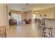 Spacious living room with tile floors, a fireplace, and access to the kitchen at 846 N Pueblo Dr # 111, Casa Grande, AZ 85122