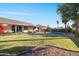 Backyard oasis with a sparkling pool and spacious grassy area at 3062 N Olympic St, Mesa, AZ 85215