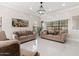 Spacious living room with beige sofas and a large chandelier at 16008 N 56Th Way, Scottsdale, AZ 85254