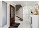 Bright entryway with a dark wood door, staircase, and white tile floors at 16008 N 56Th Way, Scottsdale, AZ 85254