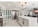 Sleek kitchen island with white cabinetry and stainless steel refrigerator at 16008 N 56Th Way, Scottsdale, AZ 85254