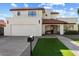 Two-story home with a white exterior, red tile roof, and artificial turf at 16008 N 56Th Way, Scottsdale, AZ 85254