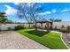 Landscaped backyard with artificial turf, gazebo and brick patio at 16008 N 56Th Way, Scottsdale, AZ 85254