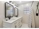 Modern bathroom with double sinks, black matte fixtures, and a walk-in shower at 16008 N 56Th Way, Scottsdale, AZ 85254