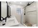 Clean bathroom with double vanity, shower, and decorative shower curtain at 16008 N 56Th Way, Scottsdale, AZ 85254