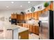 Kitchen boasts wood cabinets, tile floors, and stainless steel appliances at 2914 E Gary Way, Phoenix, AZ 85042
