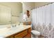 Bathroom with shower/tub, wood vanity, and patterned shower curtain at 2914 E Gary Way, Phoenix, AZ 85042
