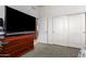 Bedroom with large TV, dresser, and double door closet at 2914 E Gary Way, Phoenix, AZ 85042