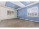 Spacious bedroom with blue walls, carpeted floors and plantation shutters at 2914 E Gary Way, Phoenix, AZ 85042