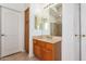 Bathroom with wood vanity, large mirror, and tiled floor at 2914 E Gary Way, Phoenix, AZ 85042