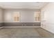 Bright bedroom with neutral walls and carpet, featuring plantation shutters and built-in shelving at 2914 E Gary Way, Phoenix, AZ 85042