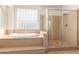 Bathroom with soaking tub, walk-in shower, and block glass window at 2914 E Gary Way, Phoenix, AZ 85042