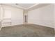 Light-filled bedroom with neutral walls and carpet, featuring built-in shelving and access to hallway at 2914 E Gary Way, Phoenix, AZ 85042