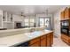 Kitchen with double sink, tile counters, and views into living room at 2914 E Gary Way, Phoenix, AZ 85042