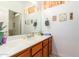 Clean bathroom featuring wood cabinets and a large vanity mirror at 2914 E Gary Way, Phoenix, AZ 85042