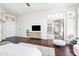 Main bedroom with hardwood floors, white furniture, and sliding glass doors at 18221 N 53Rd St, Scottsdale, AZ 85254