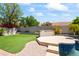 Spacious backyard with artificial turf, a built-in BBQ, and pool access at 18221 N 53Rd St, Scottsdale, AZ 85254