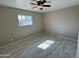 Bedroom with ceiling fan and large window at 3637 W Myrtle Ave, Phoenix, AZ 85051
