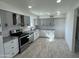 Modern kitchen with gray cabinets and granite countertops at 3637 W Myrtle Ave, Phoenix, AZ 85051