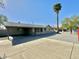 Ranch-style home with carport and mature palm tree in front at 3637 W Myrtle Ave, Phoenix, AZ 85051