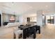 Open concept dining area with a sleek black table and modern chairs at 6921 N Joshua Tree Ct, Paradise Valley, AZ 85253